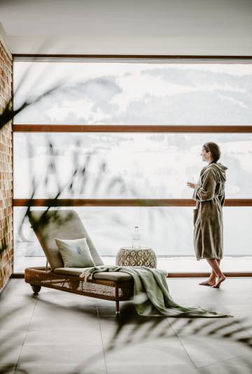Frau am Fenster von Innenpool im Bademantel