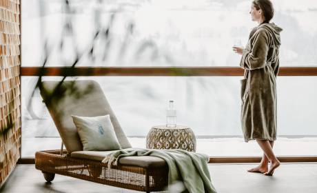 Frau im Bademantel am Pool im Winter