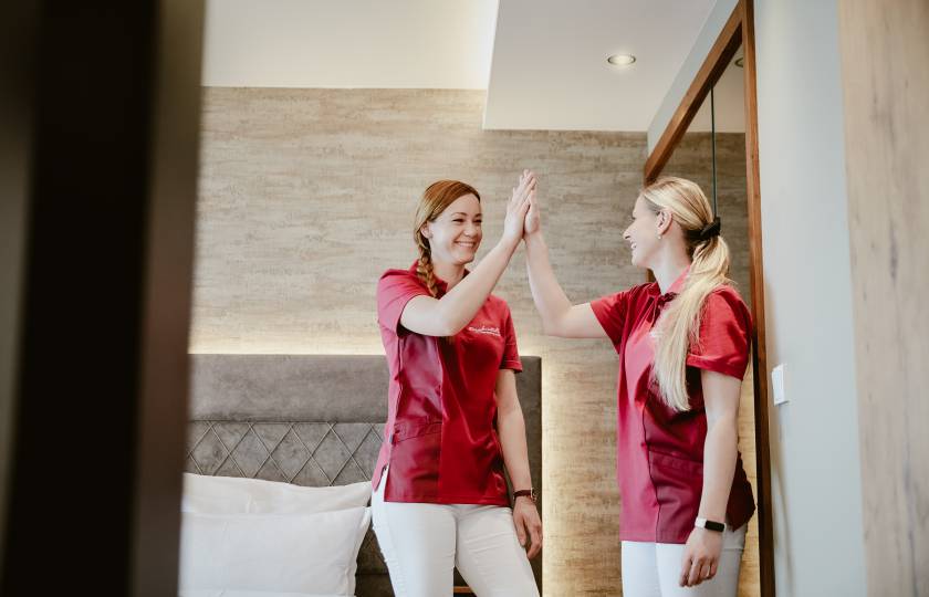 Housekeeping-Mitarbeiter des Hotels Bergkristall geben sich high five